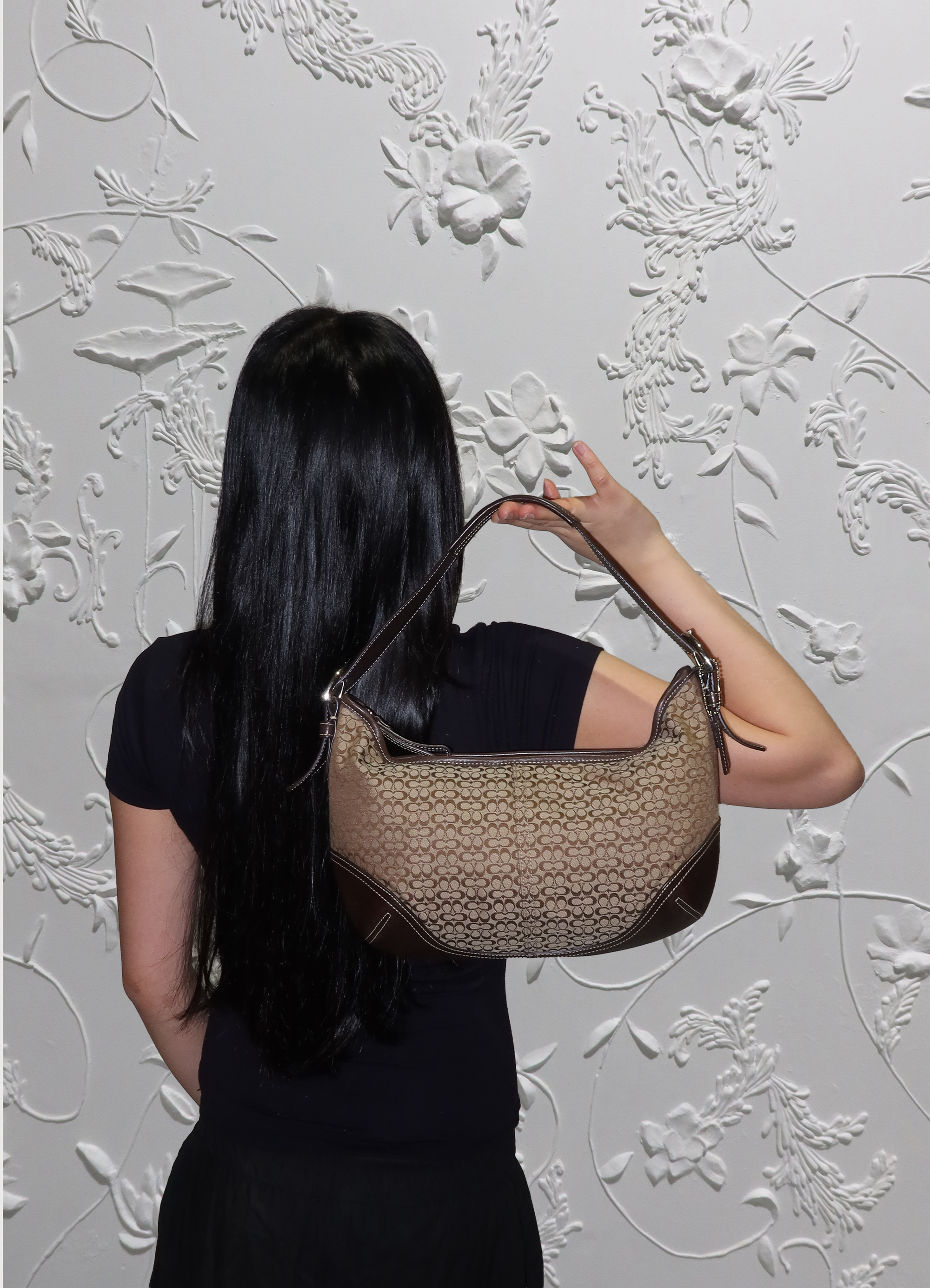 Coach Soho hobo bag held by model