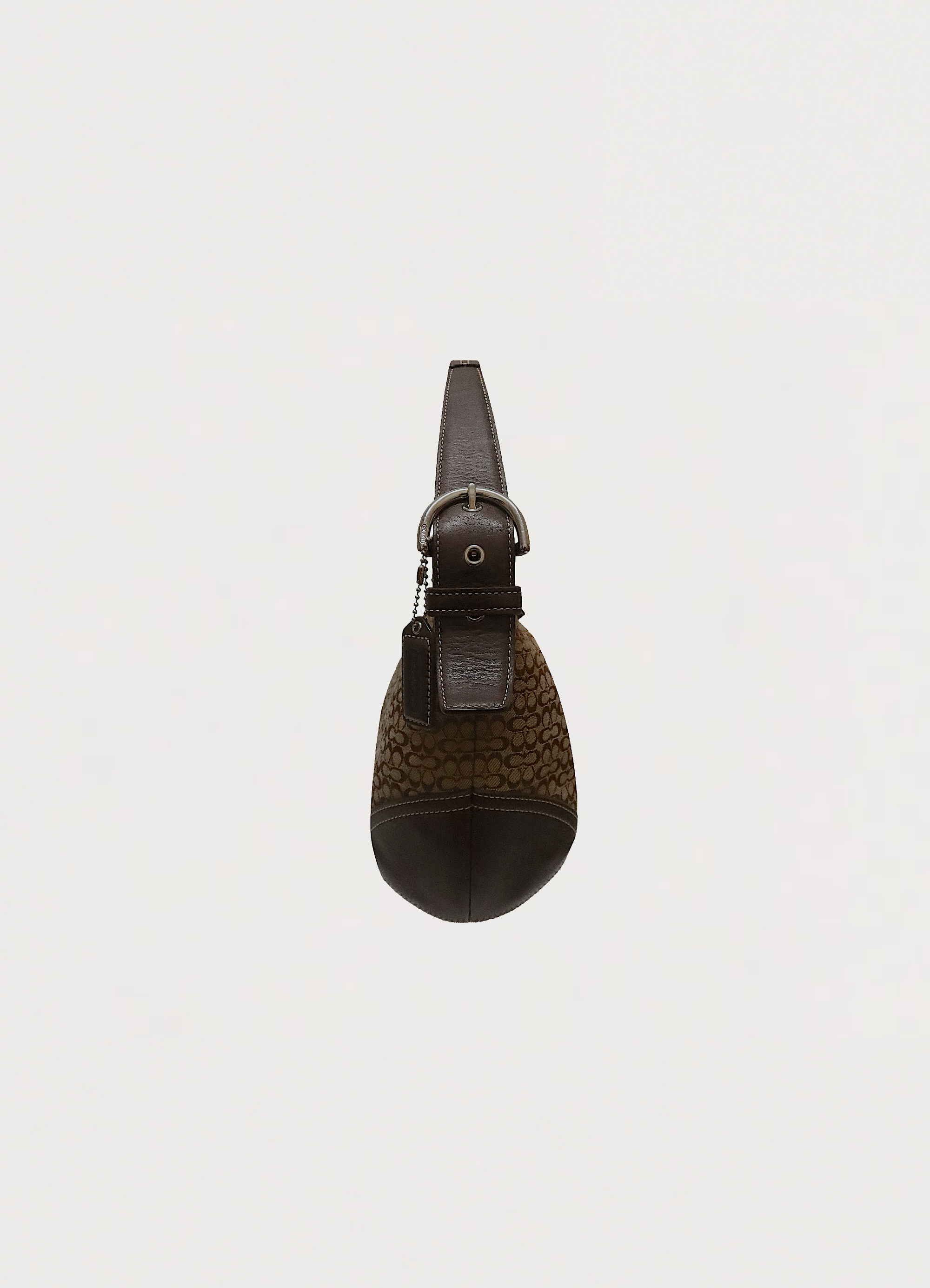 Left side profile of khaki Coach Soho hobo bag showing leather trim