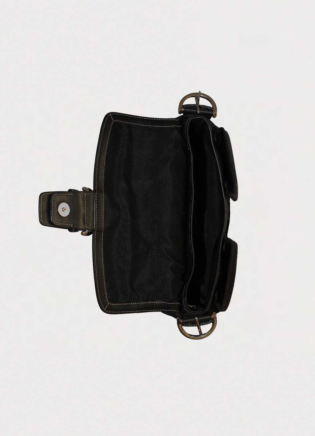 Top view into Coach Soho flap bag showing black fabric interior
