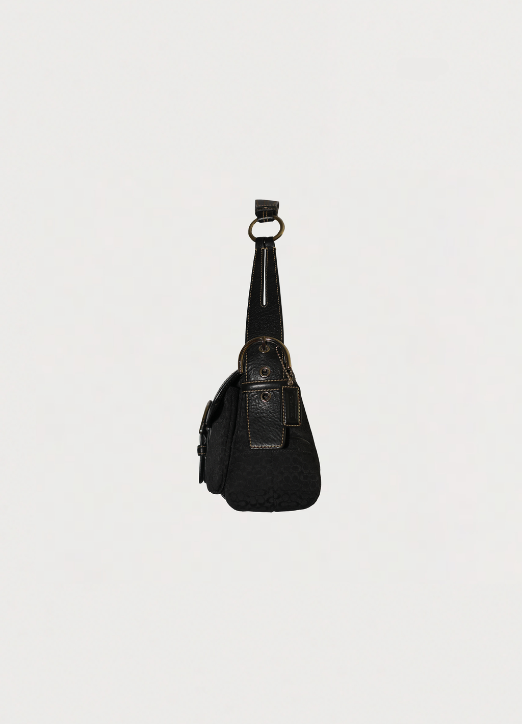Left side profile of black Coach Soho monogram flap bag