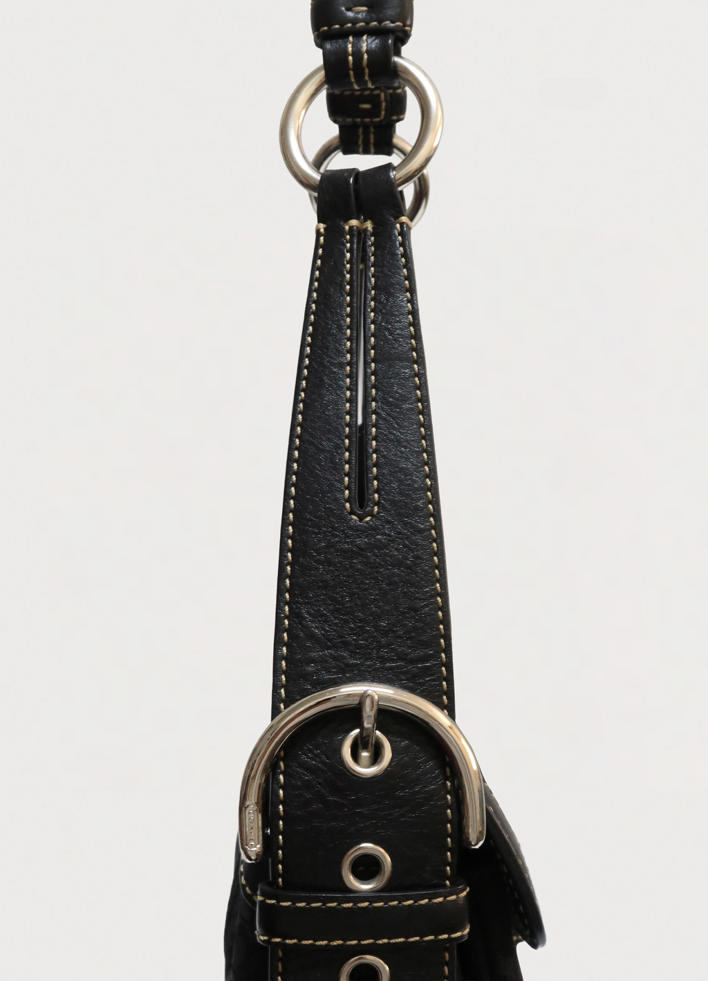Detail of the black leather shoulder strap and O-ring attachment