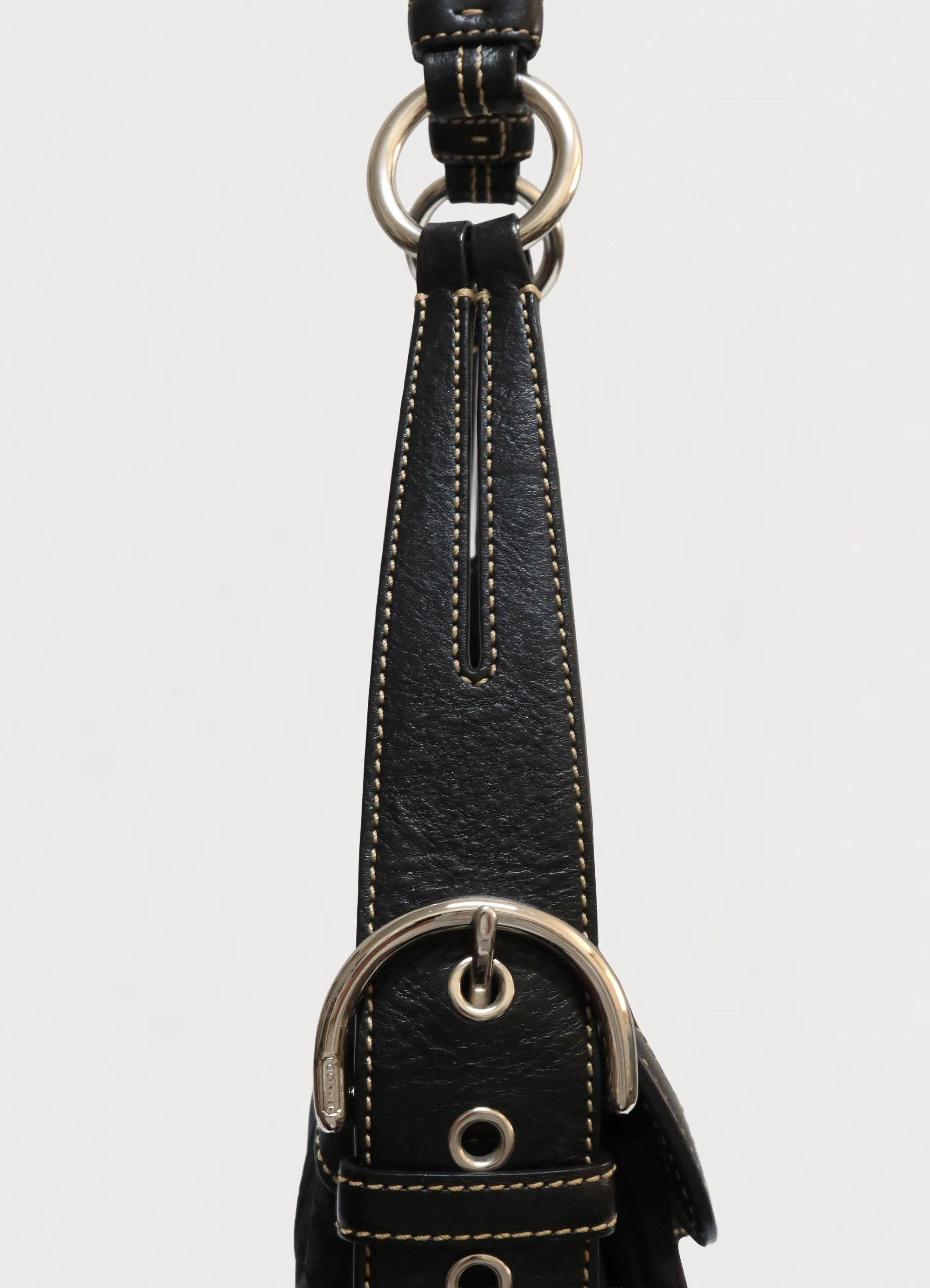 Detail of the black leather shoulder strap and O-ring attachment