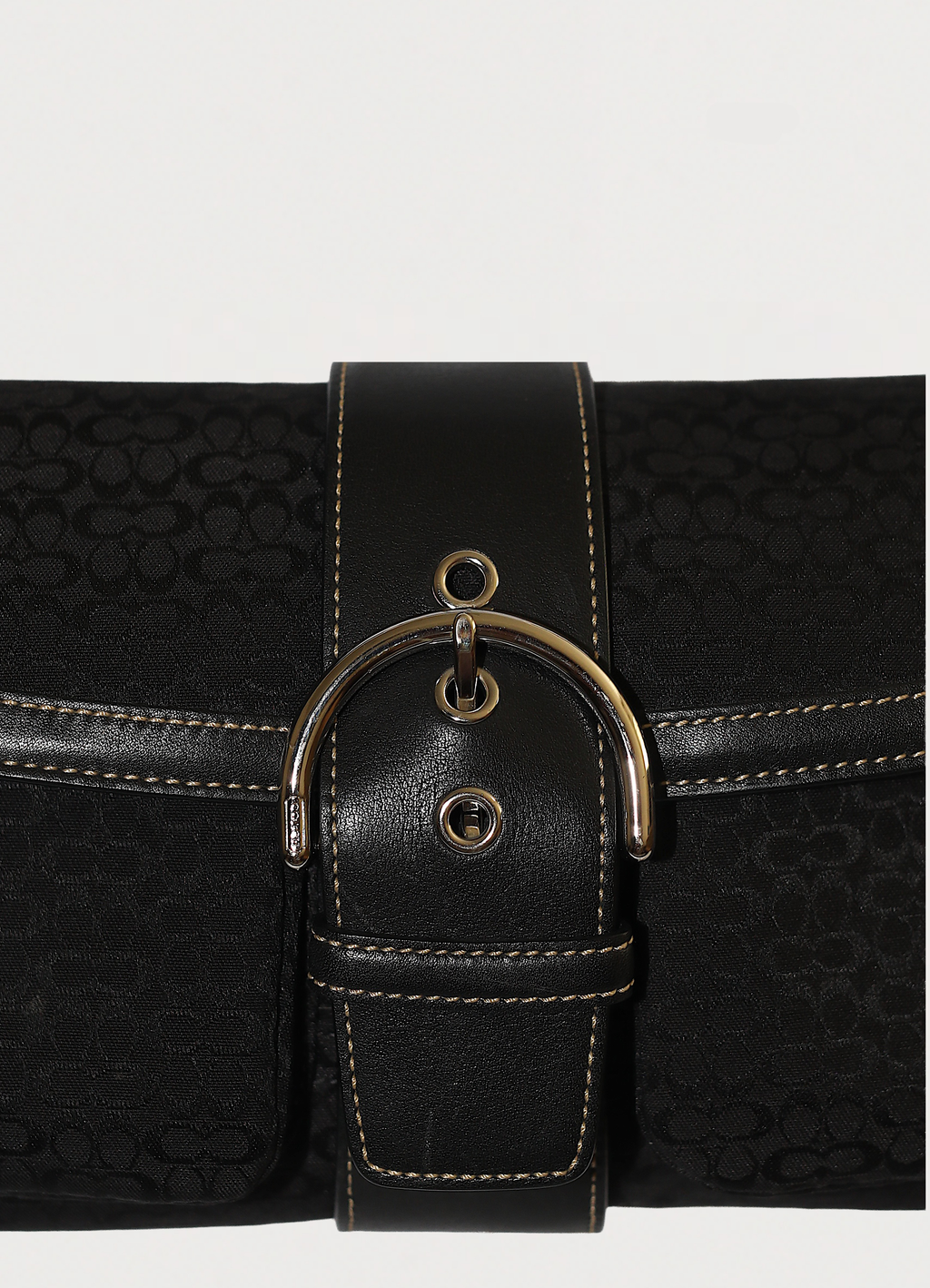 Macro shot of authentic black-on-black Coach signature jacquard canvas