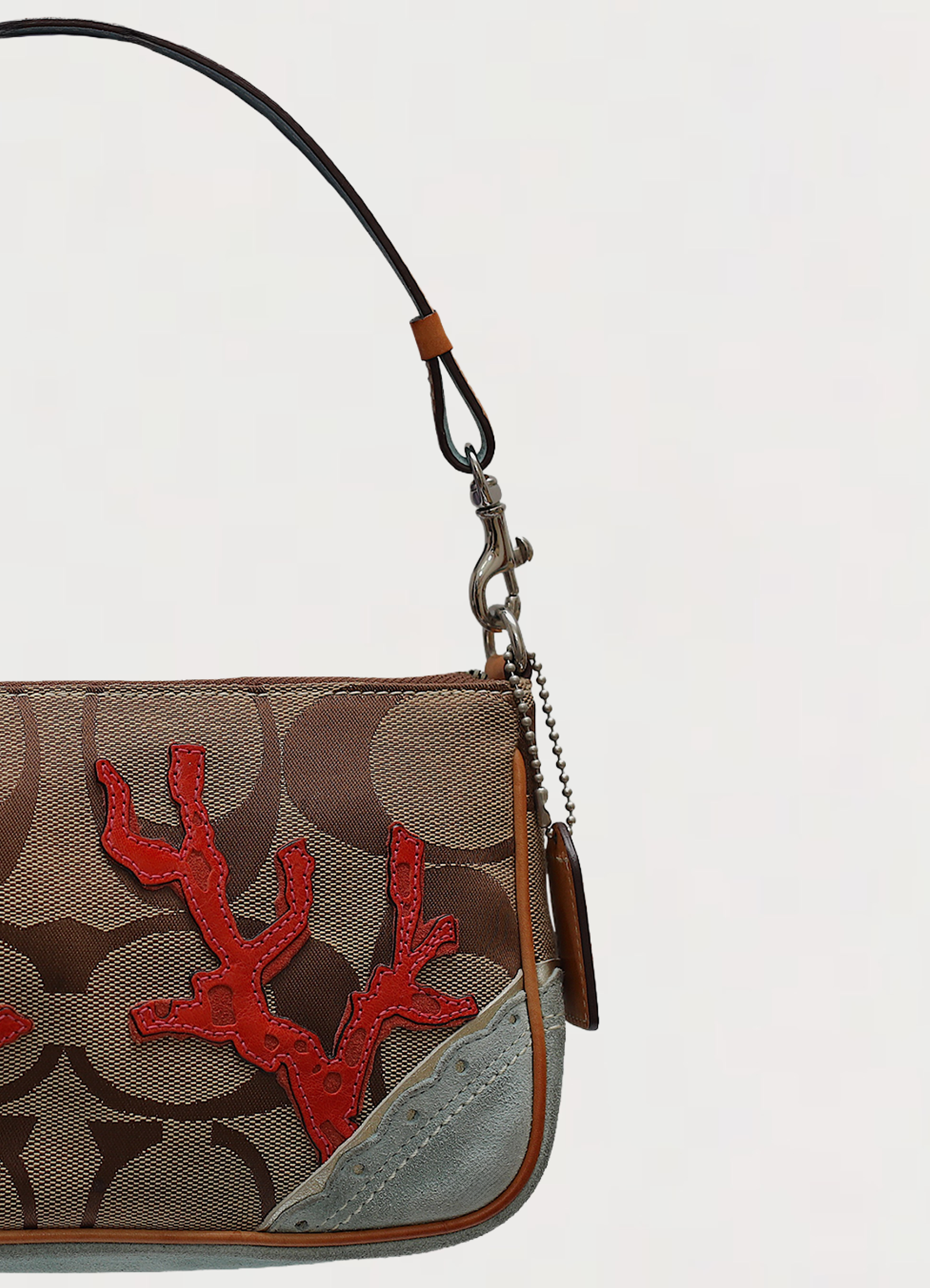 Vintage Coach Tropical Fish Demi bag in brown signature canvas with leather trim showing close up of left side