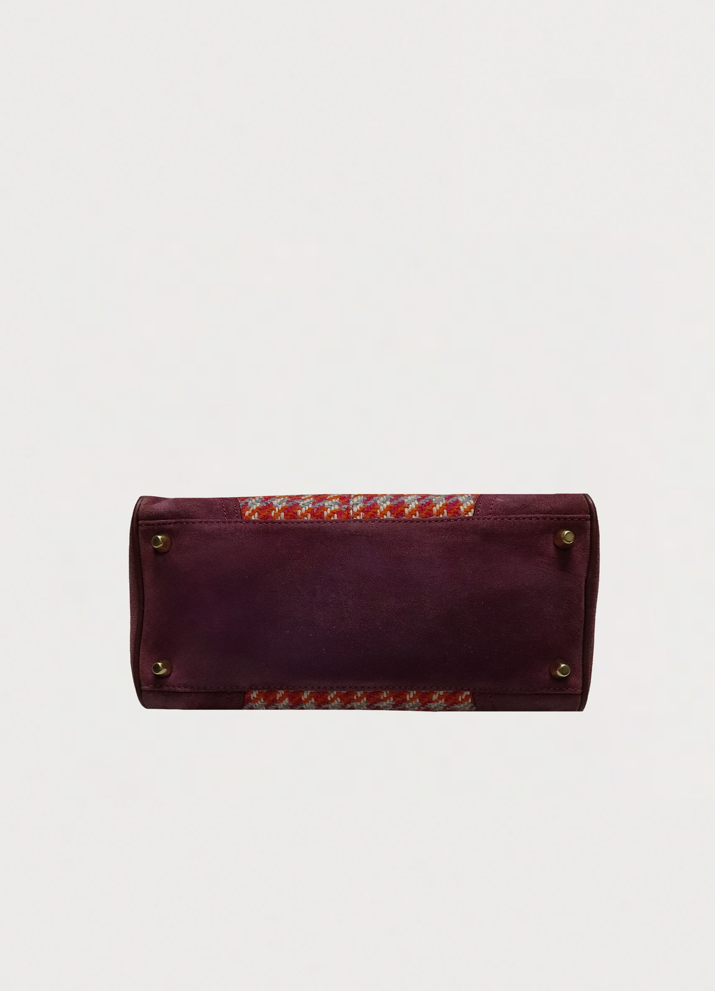 Base view of Coach Hadley satchel showing berry suede bottom and brass feet