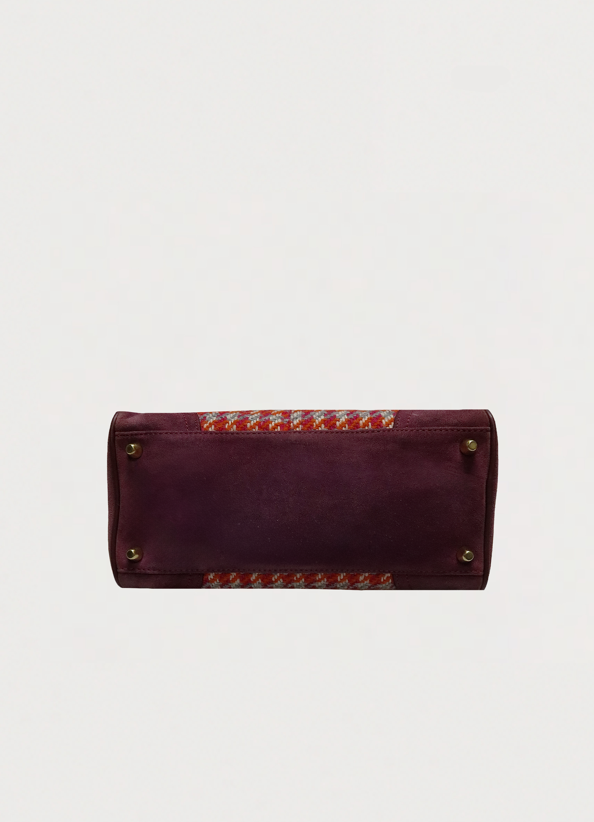 Base view of Coach Hadley satchel showing berry suede bottom and brass feet